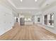 Large open living space with wood floors and modern kitchenette at 14407 Brick Church Ct, Charlotte, NC 28277