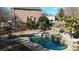 Serene backyard featuring a custom pool, spa, stone accents, and a cozy lounge area at 14407 Brick Church Ct, Charlotte, NC 28277
