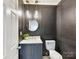 Stylish powder room featuring modern fixtures and a dark accent wall at 14407 Brick Church Ct, Charlotte, NC 28277