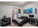 This cozy bedroom has a large bed, an accent wall, and a window letting in natural light at 1762 Tomes Rd, Lincolnton, NC 28092