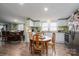 Bright kitchen with white cabinets, stainless appliances, granite counters, and a cozy breakfast table adjacent to dining area at 1762 Tomes Rd, Lincolnton, NC 28092