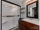 Bathroom with a walk-in shower, vanity, and shelving at 210 Goff St, Charlotte, NC 28208