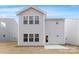 Back of house with white siding, a door, and a concrete patio at 213 Parkmont Dr # 137, Troutman, NC 28166