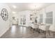 Bright dining room features wood floors, a glass table with seating for four, and a decorative light fixture at 213 Parkmont Dr # 137, Troutman, NC 28166