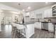 Bright, open kitchen featuring white cabinets, granite countertops, and island seating at 213 Parkmont Dr # 137, Troutman, NC 28166