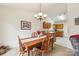 Warm dining space with wooden table set, chandelier lighting, and easy access to the adjacent kitchen at 2364 Nuthatch Dr, Rock Hill, SC 29732