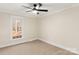 Well-lit bedroom with a large window which has a great view of the yard and the surrounding trees at 2401 High Ridge Rd, Charlotte, NC 28270