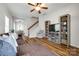 Open living room with stylish shelving, a staircase, wood floors, and view into the dining area at 265 Makayla Ct, Fort Mill, SC 29715