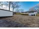 Rear view of a new utility shed, deck and large backyard, perfect for storage and outdoor living at 3004 Briarwood Ln, Gastonia, NC 28056
