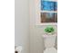Bathroom featuring a white toilet, neutral paint, and a window, creating a serene and bright space at 3004 Briarwood Ln, Gastonia, NC 28056