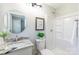 A bathroom featuring a granite countertop sink, a toilet with decor, and a stand-up shower at 3004 Briarwood Ln, Gastonia, NC 28056
