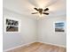 Bedroom boasts wood floors, two bright windows, neutral paint, and a ceiling fan with lights at 3004 Briarwood Ln, Gastonia, NC 28056