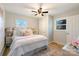 Cozy bedroom featuring wood floors, a ceiling fan, neutral paint, and a well-lit and inviting space at 3004 Briarwood Ln, Gastonia, NC 28056