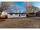Charming white brick home with a manicured lawn and a convenient covered carport at 3004 Briarwood Ln, Gastonia, NC 28056