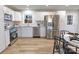 Bright kitchen with stainless steel appliances, white cabinets, and wood flooring at 3004 Briarwood Ln, Gastonia, NC 28056