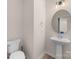Clean half bathroom with pedestal sink, round mirror, and modern fixtures at 315 Skyebrook Ln, Rock Hill, SC 29730