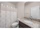 Well-lit bathroom with a granite countertop, framed mirror, and a shower with decorative curtains at 315 Skyebrook Ln, Rock Hill, SC 29730