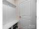 Organized entryway with coat hooks, a bench, and shoe storage, by the front door at 315 Skyebrook Ln, Rock Hill, SC 29730