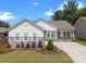 Inviting one-story home featuring stone accents, manicured landscaping, and a spacious driveway under a bright sky at 315 Skyebrook Ln, Rock Hill, SC 29730