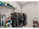 Laundry room featuring modern washer and dryer units, plus storage shelves and cleaning supplies at 315 Skyebrook Ln, Rock Hill, SC 29730
