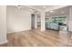 Bright, open living space with wood flooring leading to a cozy sitting area and glimpses of the kitchen at 315 Skyebrook Ln, Rock Hill, SC 29730