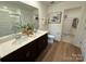 Bright bathroom features double sinks, wood floors, framed mirror, closet, and ample counter space at 326 Knotty Wood Dr # 66, Monroe, NC 28110