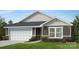 Charming one-story home with stone accents, gray siding, well-maintained landscaping, and an attached two-car garage at 326 Knotty Wood Dr # 66, Monroe, NC 28110
