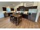 Modern kitchen features stainless steel appliances, dark cabinets and a center island at 326 Knotty Wood Dr # 66, Monroe, NC 28110