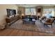 Bright living room features a large rug, comfortable seating, and large windows at 326 Knotty Wood Dr # 66, Monroe, NC 28110