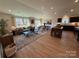 Open concept living room flows from Gathering room to kitchen with modern finishes at 326 Knotty Wood Dr # 66, Monroe, NC 28110