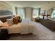 Bright and spacious main bedroom features large windows and a cozy sitting area at 326 Knotty Wood Dr # 66, Monroe, NC 28110
