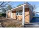 Brick ranch home with a covered porch and driveway at 3721 Braden Dr, Charlotte, NC 28216
