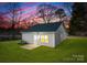 Exterior view of the house features large backyard, patio, and beautiful evening sky at 404 Killian Ave, Mount Holly, NC 28120