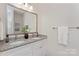 Bathroom featuring double sinks, granite vanity top, framed mirror, and a towel rack at 404 Killian Ave, Mount Holly, NC 28120