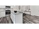 Modern kitchen island features granite countertops, a breakfast bar, and stainless steel appliances at 404 Killian Ave, Mount Holly, NC 28120