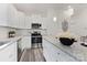 Bright kitchen features white cabinets, granite countertops, stainless steel appliances, and modern pendant lights at 404 Killian Ave, Mount Holly, NC 28120