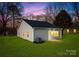 Charming gray home featuring a well-kept lawn, updated HVAC system, and a serene twilight sky at 404 Killian Ave, Mount Holly, NC 28120