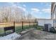 Backyard featuring a well maintained lawn with a wooded backdrop and dark metal fencing at 4194 La Crema Dr, Charlotte, NC 28214