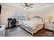 Comfortable bedroom with a plush bed, a ceiling fan, and a dedicated workspace near the window at 4194 La Crema Dr, Charlotte, NC 28214
