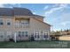 Back exterior view of home showcasing the patio, deck and well-manicured lawn at 4194 La Crema Dr, Charlotte, NC 28214