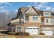 Beautiful townhome featuring a stone facade and a two-car garage at 4194 La Crema Dr, Charlotte, NC 28214