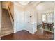 Inviting foyer with hardwood floors, stairs, and view into the dining room at 4194 La Crema Dr, Charlotte, NC 28214