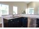 Stylish kitchen with granite countertops, dark cabinets, and stainless steel appliances, a chef's dream space at 4194 La Crema Dr, Charlotte, NC 28214