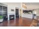 Cozy living room with fireplace, built-in shelving, view into kitchen, and hardwood floors at 4194 La Crema Dr, Charlotte, NC 28214