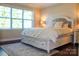 Comfortable main bedroom featuring a decorative bed frame, soft rug, and bright natural light, perfect for relaxation at 4194 La Crema Dr, Charlotte, NC 28214