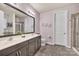 Bathroom featuring a double sink vanity, patterned wallpaper, and a glass-enclosed shower at 4929 Norman Park Pl, Clover, SC 29710