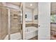 Bathroom featuring a glass shower and separate soaking tub in a tiled surround at 4929 Norman Park Pl, Clover, SC 29710