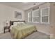 Cozy bedroom with a queen bed, three windows for natural light, and carpet flooring at 4929 Norman Park Pl, Clover, SC 29710