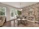 Cozy dining area with a glass table, four chairs, and a modern accent wall at 4929 Norman Park Pl, Clover, SC 29710