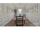 Elegant dining room with a long wooden table, seating for eight, and decorative wall art at 4929 Norman Park Pl, Clover, SC 29710